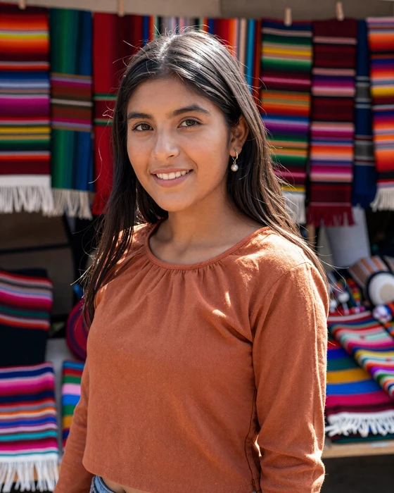 Ecuadorian woman at the colorful Otavalo indigenous market - traditional Andean beauty for ecuadorian brides
